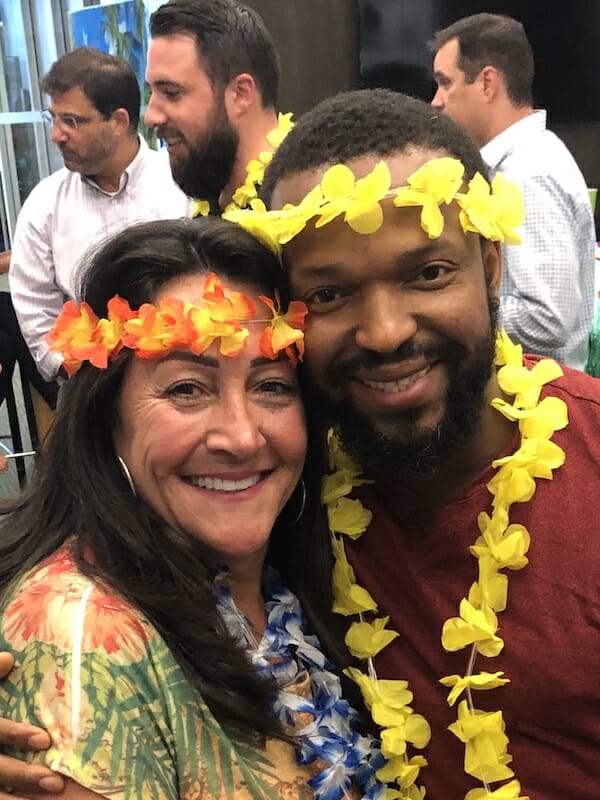 Happy employees wearing luau leis