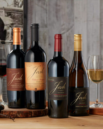 Josh cellars reserve bottles lined up with wine glasses