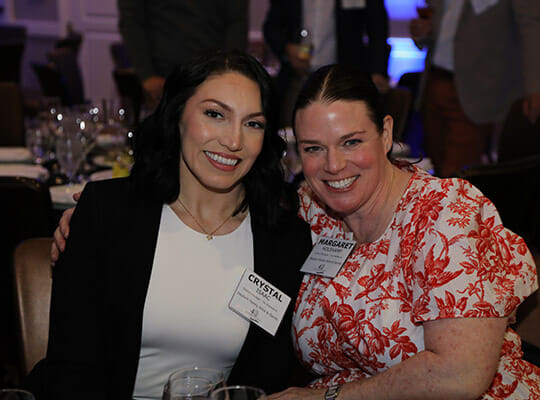 Two women attending company event