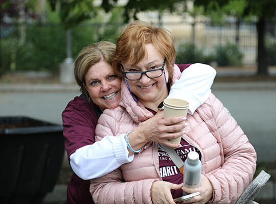 Two women hugging and smiling